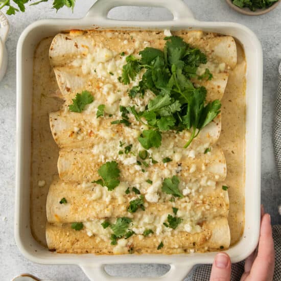 enchiladas in a white baking dish.