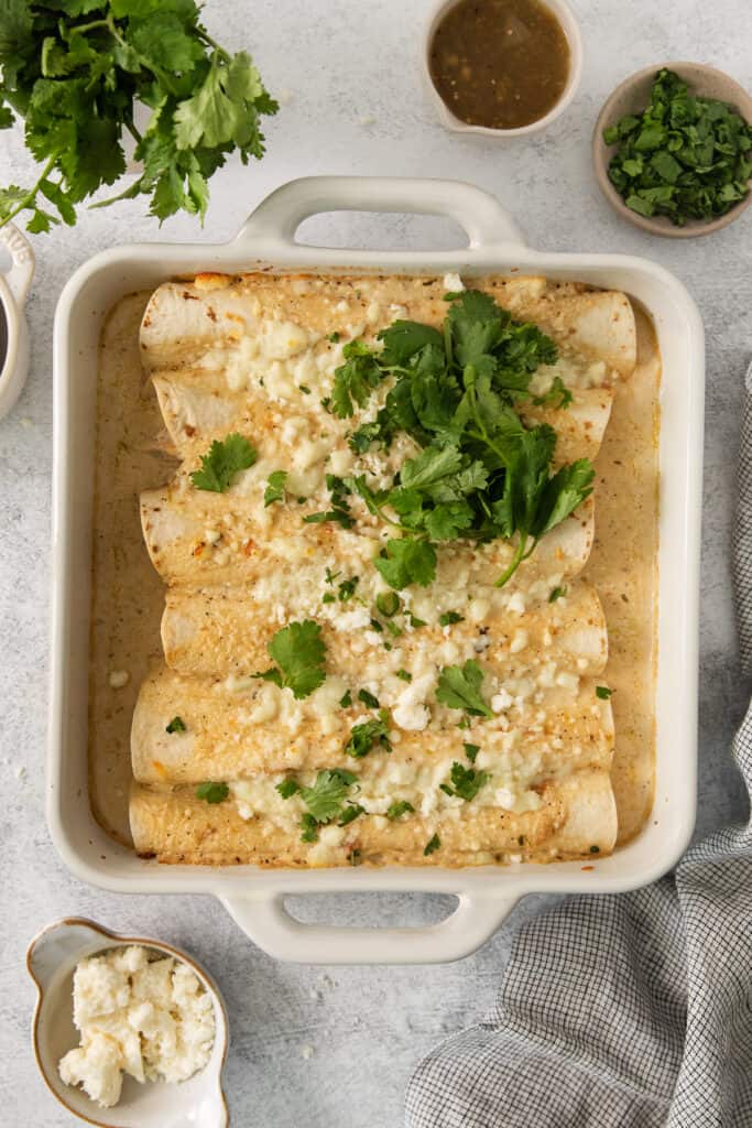 mexican enchiladas in a white baking dish.