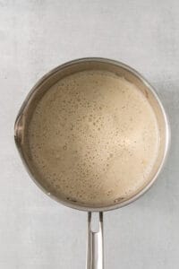 a pan with liquid in it on a white background.