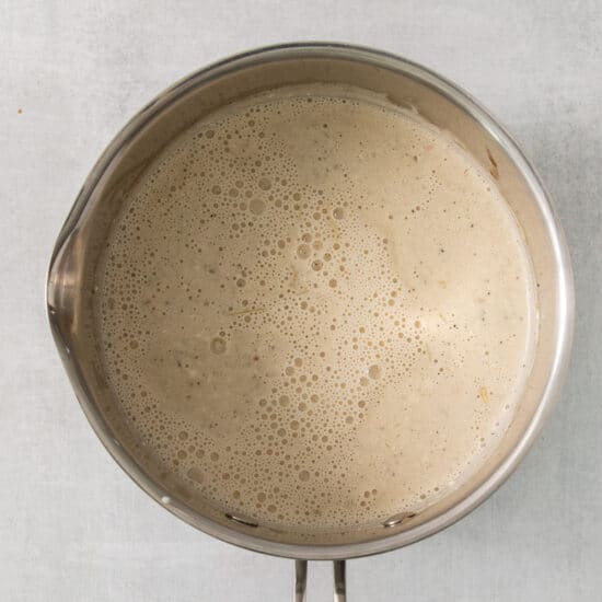 a pan with liquid in it on a white background.