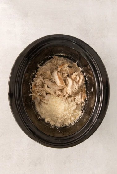 a bowl of chicken and rice in a slow cooker.