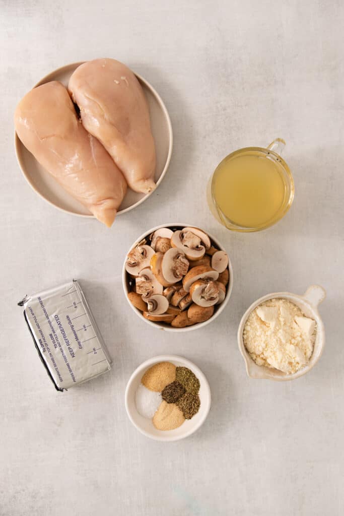 the ingredients for a chicken recipe are shown on a white table.