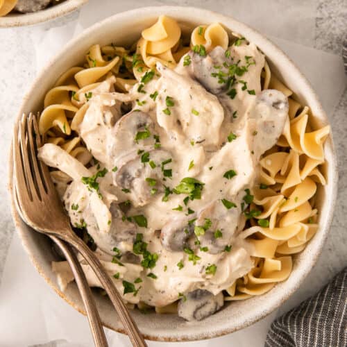 a bowl of mushroom risotto with a fork.