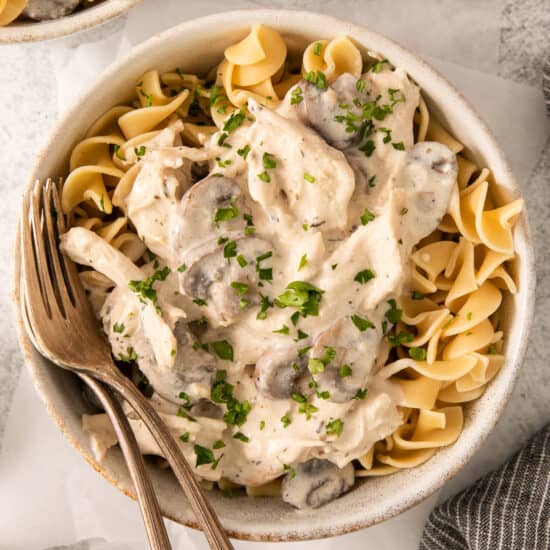 a bowl of mushroom risotto with a fork.