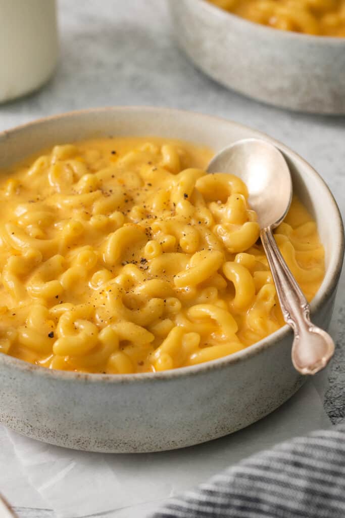 macaroni and cheese in a bowl with a spoon.