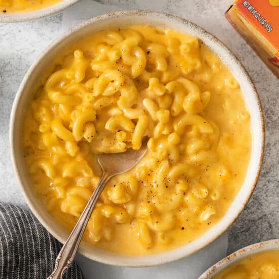 macaroni and cheese in a bowl with a spoon.
