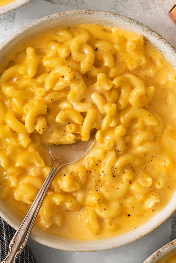 macaroni and cheese in a bowl with a spoon.