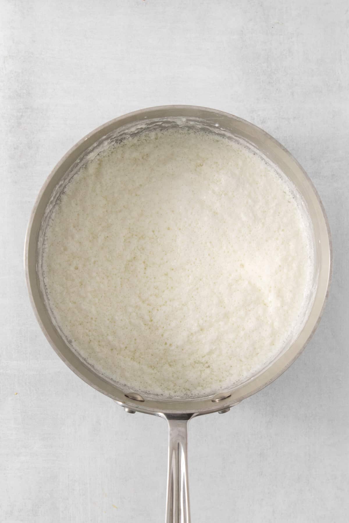 white rice in a pan on a white background.