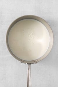 a pan with milk in it on a white background.