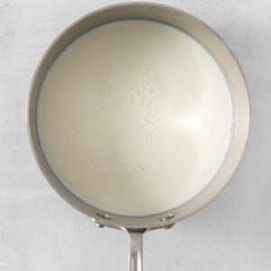 a pan with milk in it on a white background.