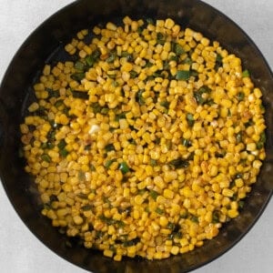 corn in a skillet on a white background.