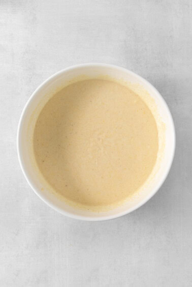 a bowl of soup on a white surface.