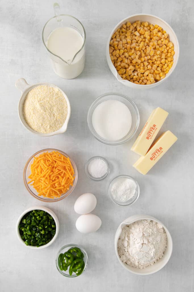 the ingredients for a cornbread recipe are laid out on a table.