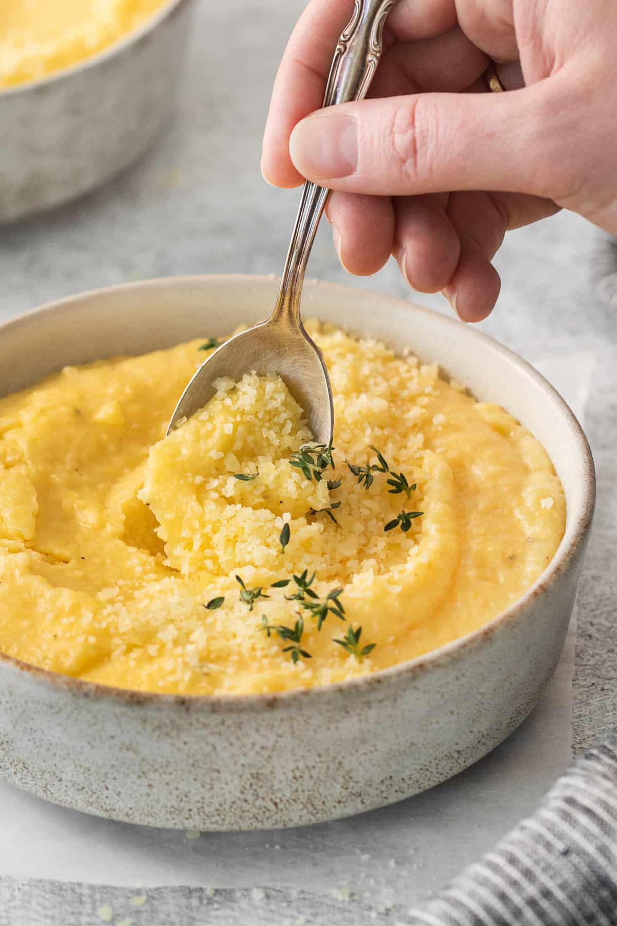 a bowl of mashed potatoes with a spoon in it.