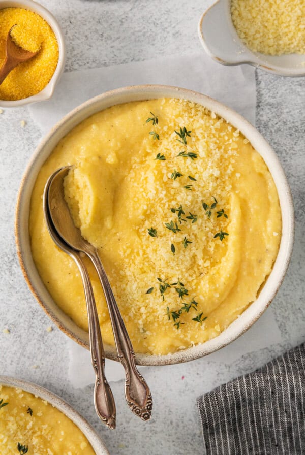 a bowl of mashed potatoes with a spoon in it.