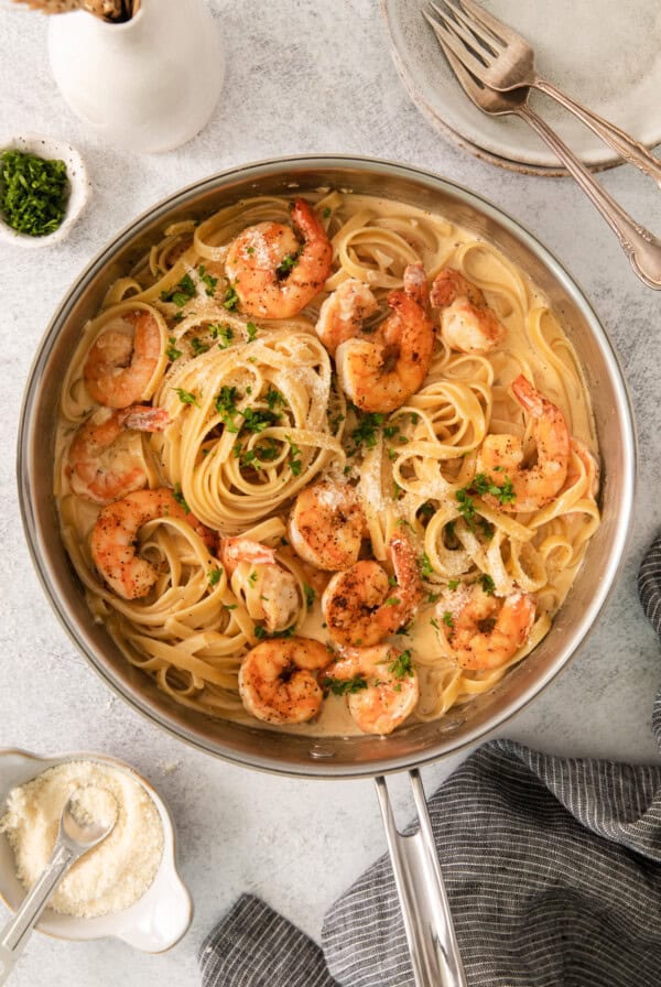 a pan with shrimp and pasta in it.