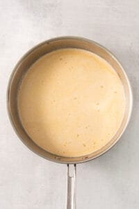 a frying pan with a yellow liquid in it.