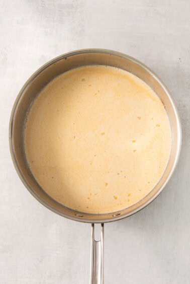 a frying pan with a yellow liquid in it.