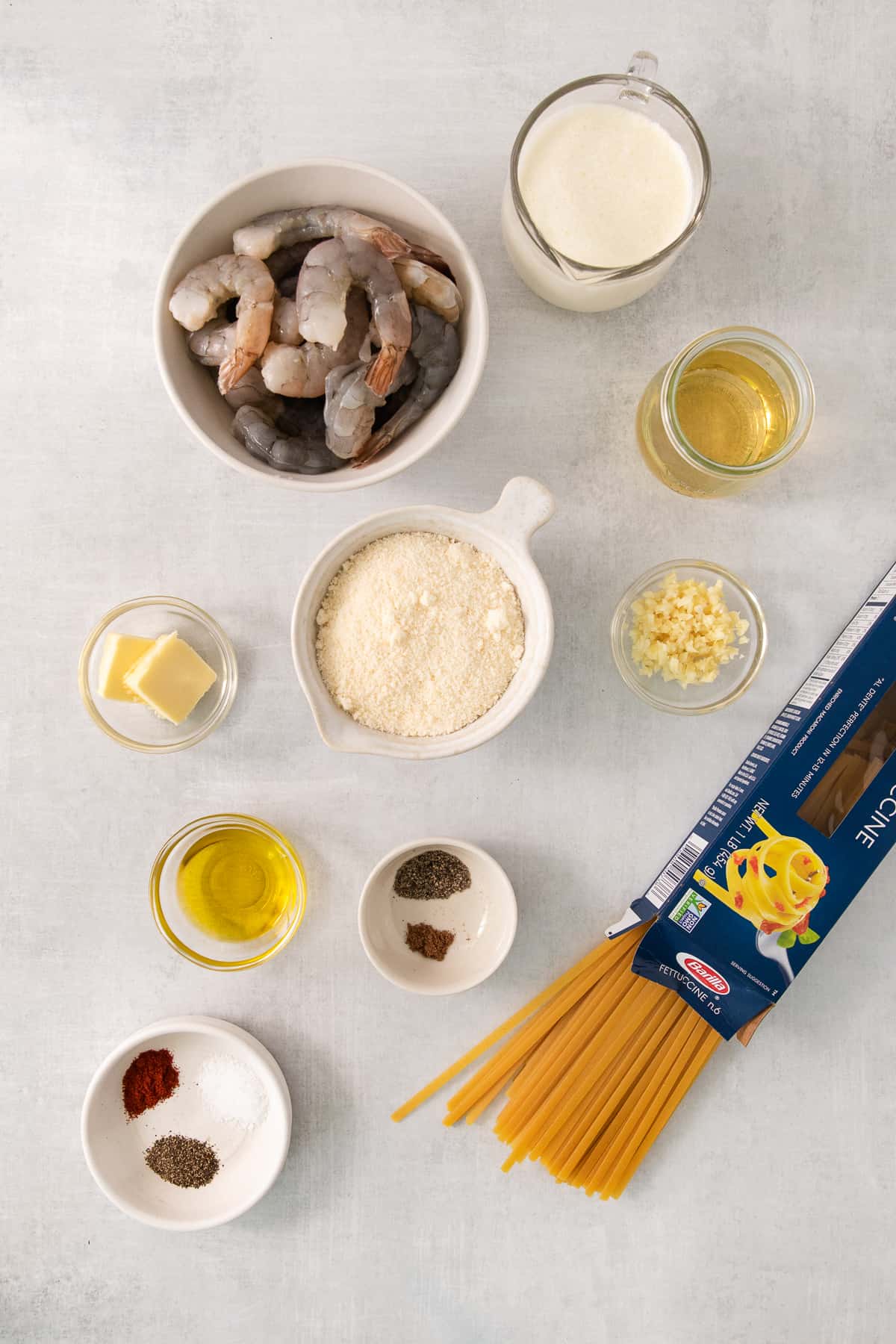 the ingredients for a pasta dish are laid out on a table.