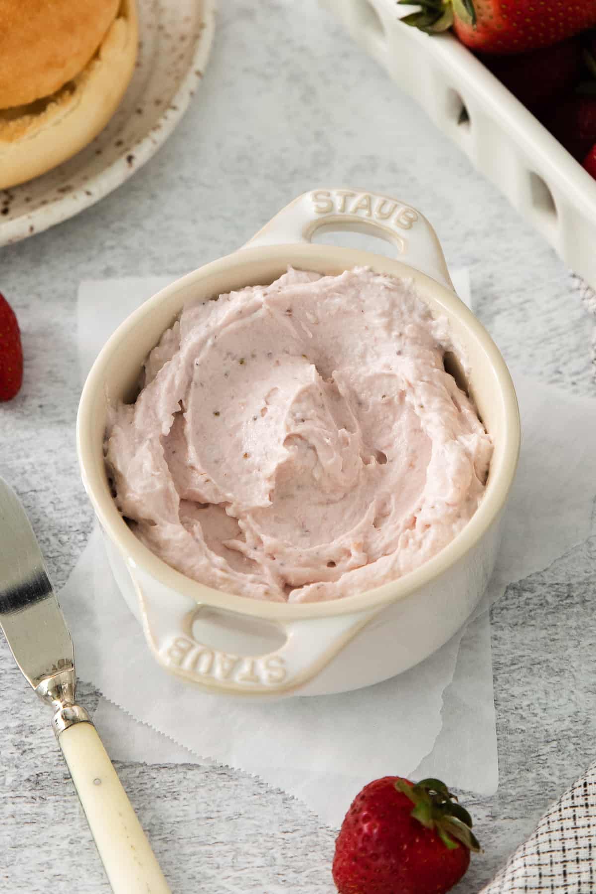 a bowl of strawberry jam with strawberries and a fork.