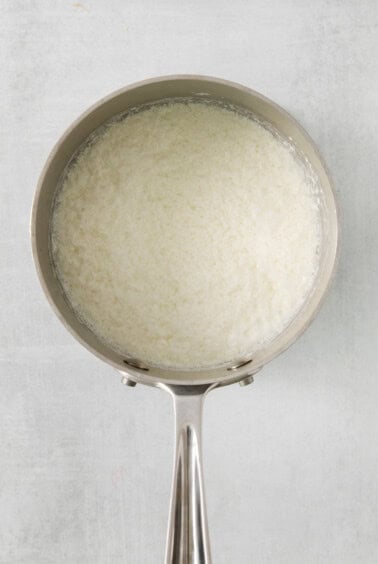 rice in a pan on a white background.