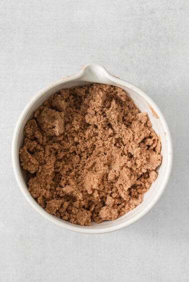 cocoa powder in a white bowl on a white background.