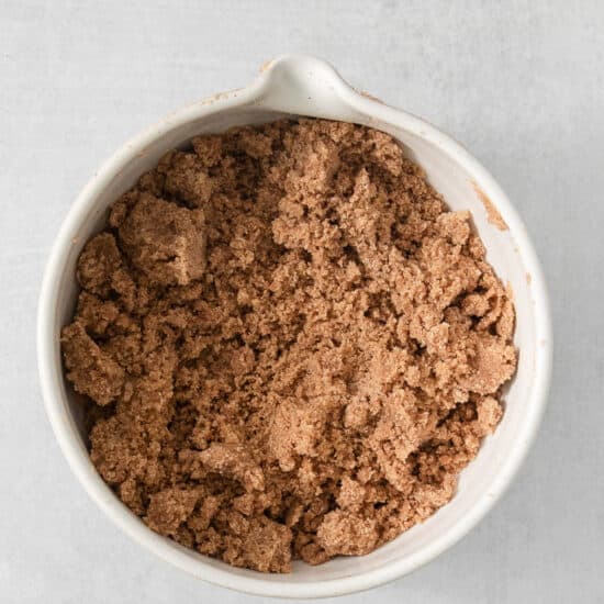 cocoa powder in a white bowl on a white background.