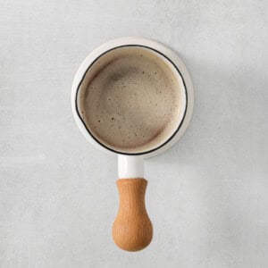 a coffee mug with a wooden handle on it.