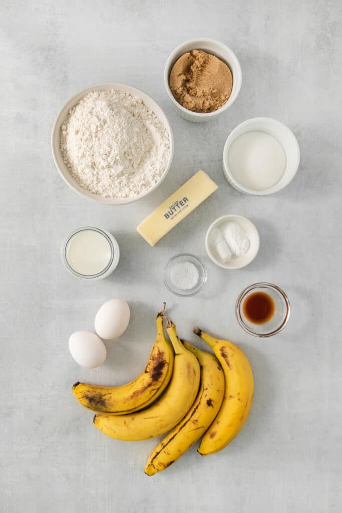 banana bread ingredients on a grey background.