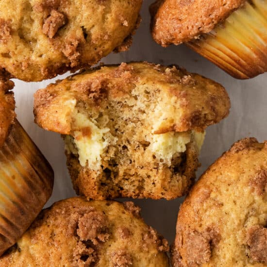 a group of muffins with a bite taken out of them.