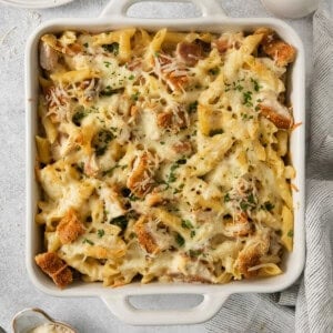 a casserole dish with chicken and pasta in it.