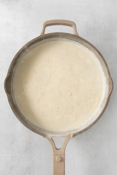a frying pan with a sauce on it.