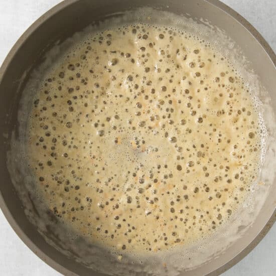 a frying pan with a brown liquid in it.