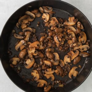 mushrooms in a skillet on a white background.