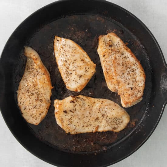 chicken breasts in a cast iron skillet.