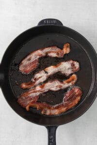 bacon in a skillet on a white background.