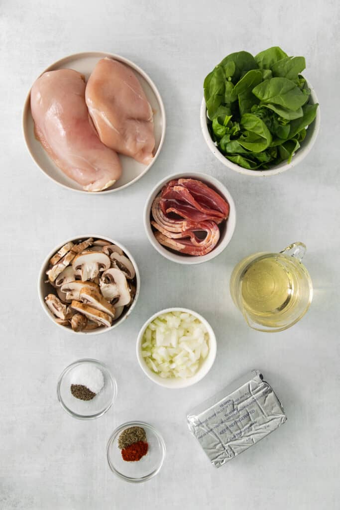 chicken parmigiana ingredients on a white table.