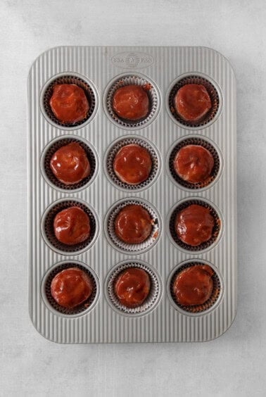 a muffin tin filled with cupcakes.