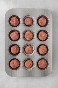 a muffin tin filled with meatballs.