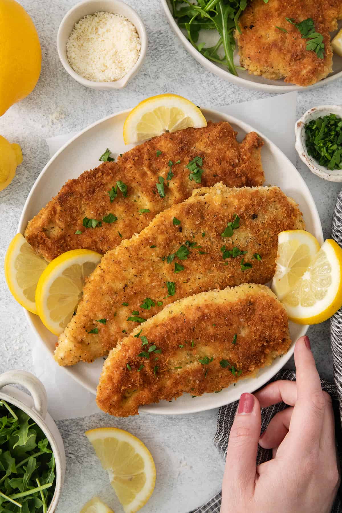 fish fillets with lemon and parsley on a plate.