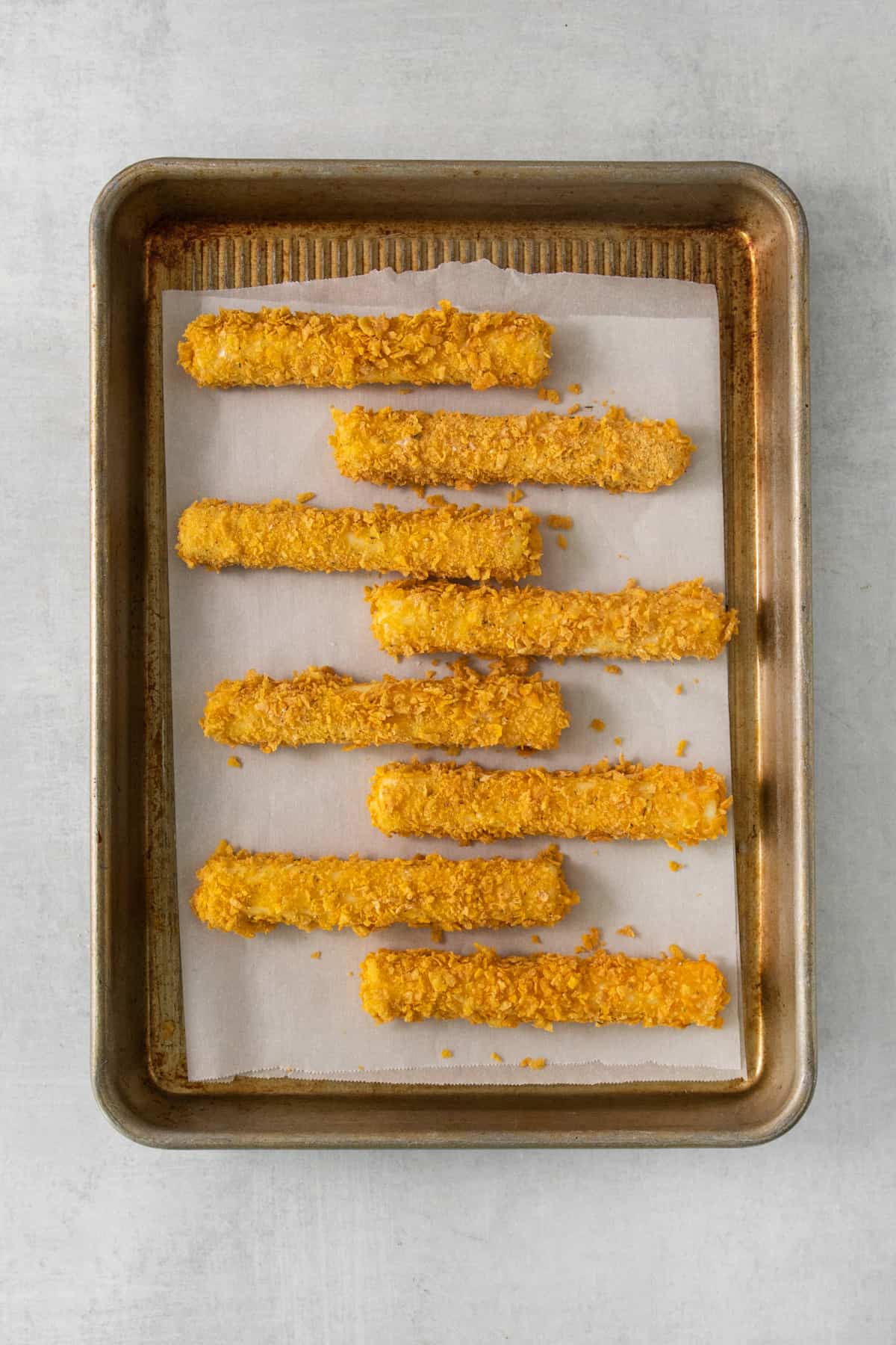 fried potato sticks on a baking sheet.