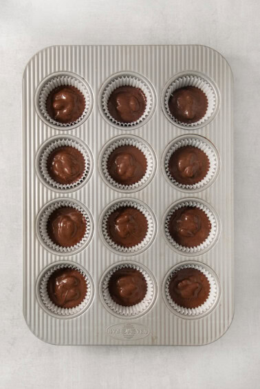 a muffin tin filled with chocolate cupcakes.