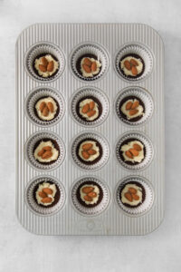 a muffin tin with twelve cupcakes in it.