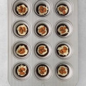 a muffin tin with twelve cupcakes in it.