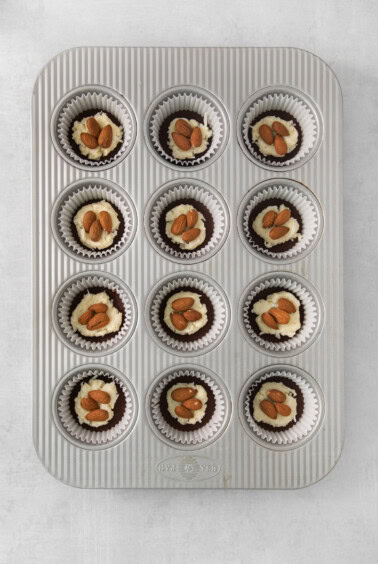 a muffin tin with twelve cupcakes in it.