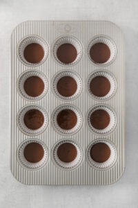 a muffin tin filled with chocolate cupcakes.