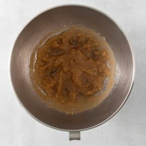 a metal bowl filled with food on top of a table.