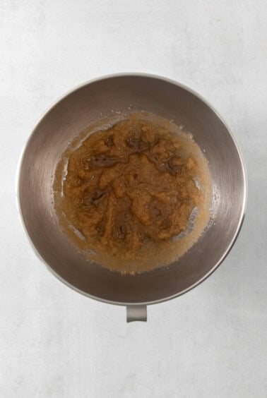 a metal bowl filled with food on top of a table.
