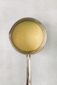 a metal spoon with a liquid inside of it.
