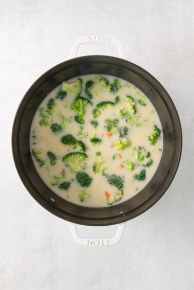 a bowl of soup with broccoli in it.